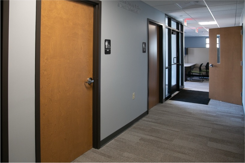 People in a public building protected by SlamFreer® door slam safety solutions for safer and quieter shared spaces.